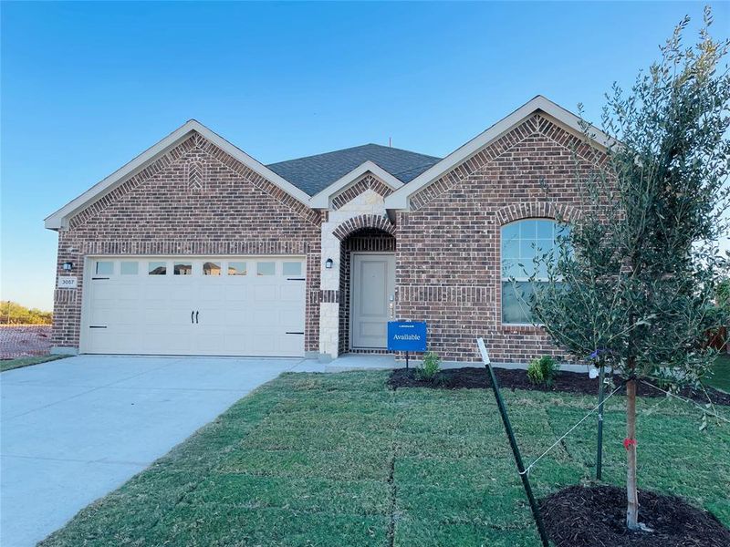 View of front facade with a garage and a front lawn