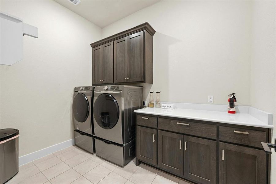 Huge laundry room with plenty of built in cabinetry.