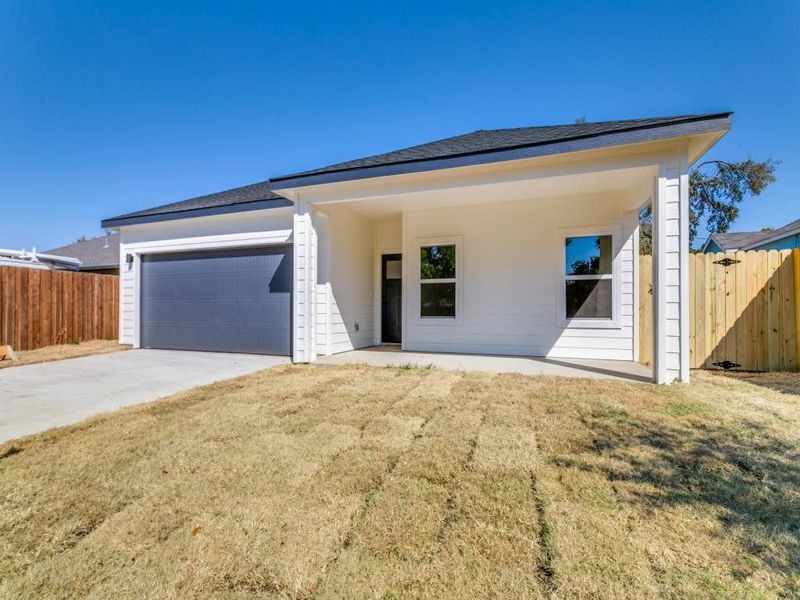 View of front facade with a front yard and a garage