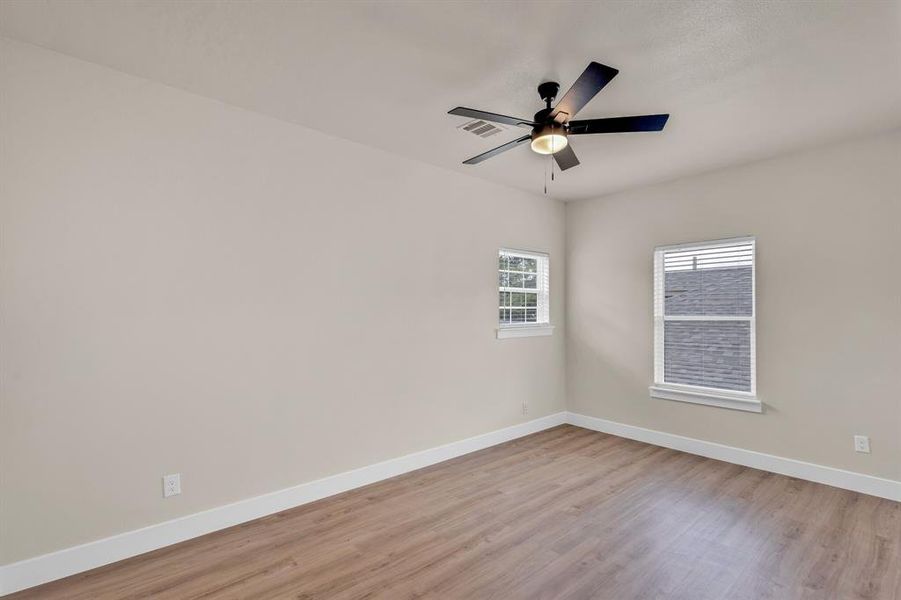 Unfurnished room featuring light hardwood / wood-style floors and ceiling fan