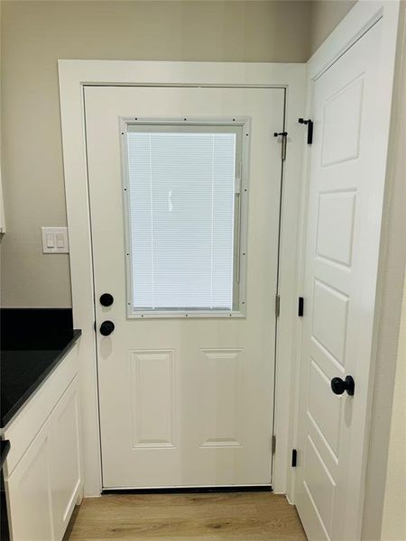 Doorway to outside featuring light wood-type flooring