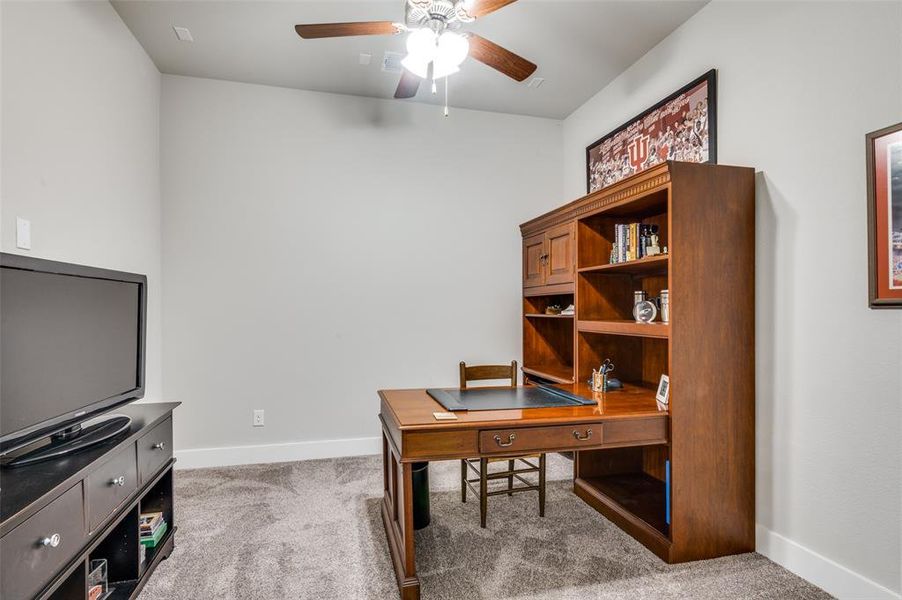 Office space with ceiling fan and carpet flooring