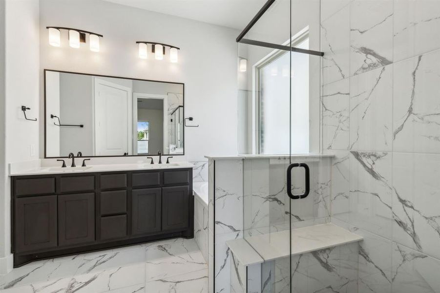 Bathroom featuring vanity and independent shower and bath