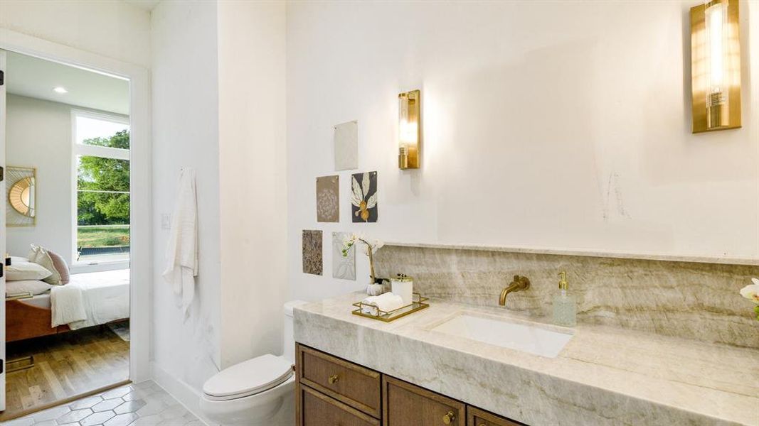 Bathroom featuring hardwood / wood-style flooring, toilet, and vanity