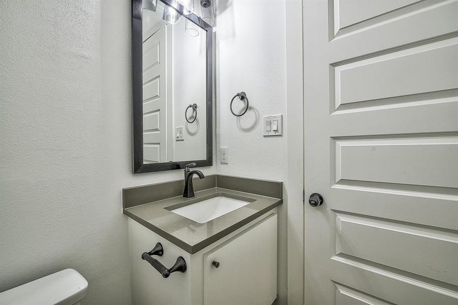 Bathroom featuring vanity and toilet