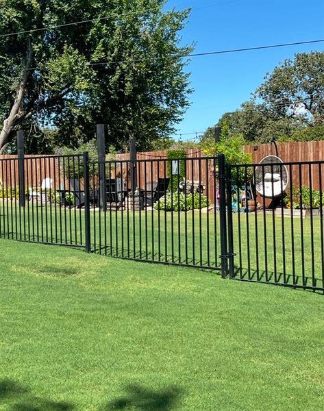 View of metal fence to the back yard