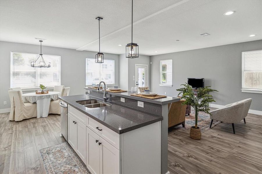 Kitchen island with quart counters and breakfast bar.