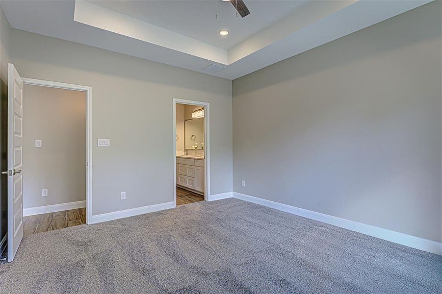 Owner's suite with raised ceiling.