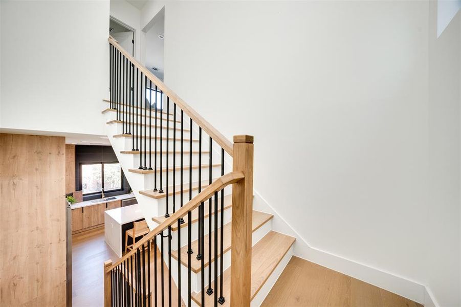 Staircase featuring hardwood / wood-style flooring