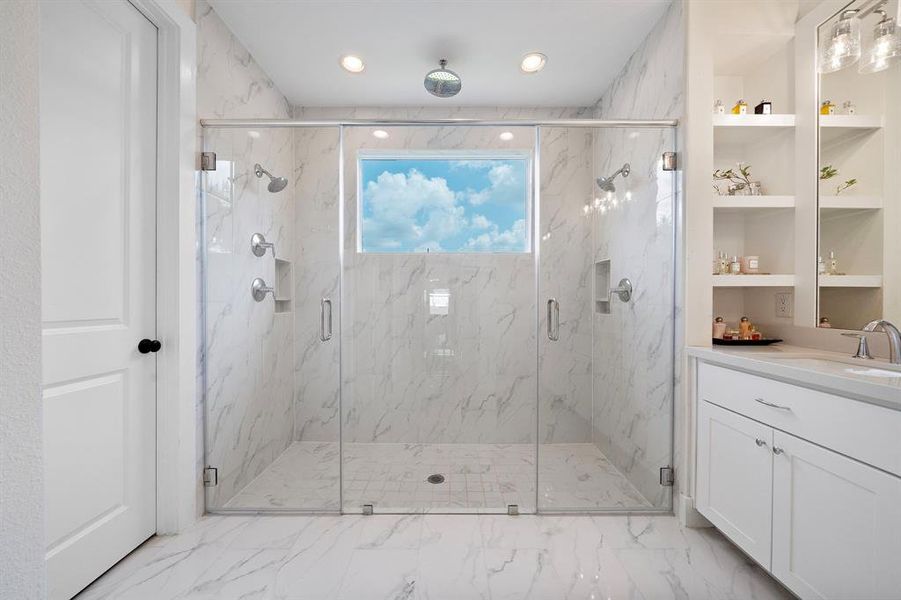 Lavish shower with rainfall feature, dual sided design, and just the right amount of natural light.