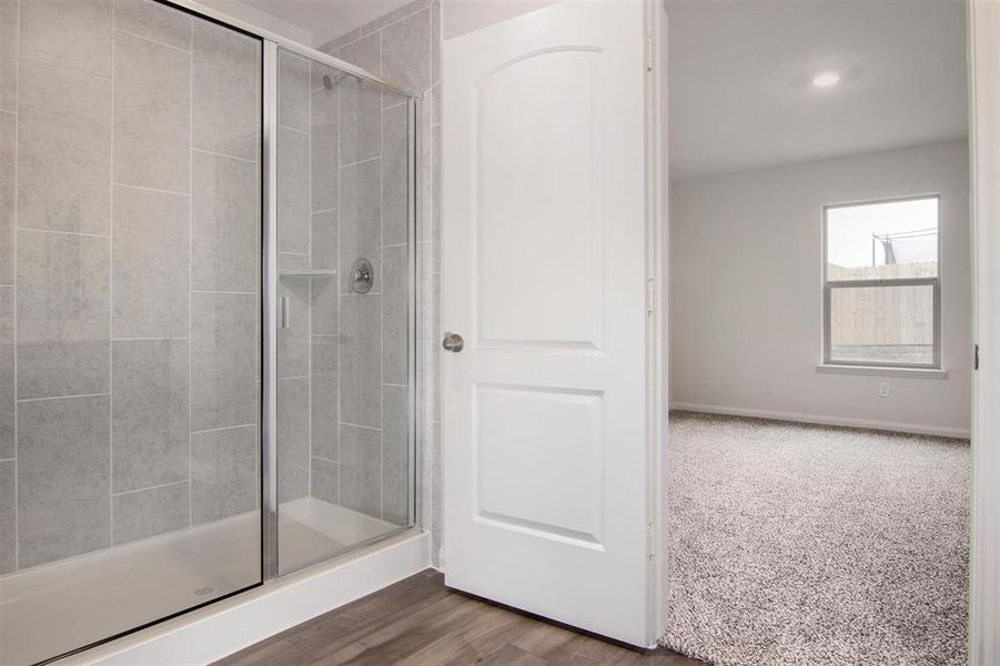 Bathroom with walk in shower and hardwood / wood-style flooring