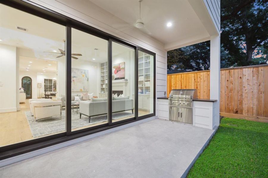 Covered Patio with Tile, Built-In Grill with Slab Granite Counter and Double Stainless Doors for under-counter storage.