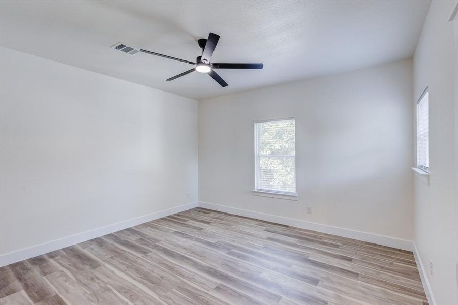 Spare room featuring ceiling fan and light hardwood / wood-style flooring