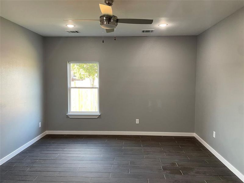 Spare room with ceiling fan and dark hardwood / wood-style flooring