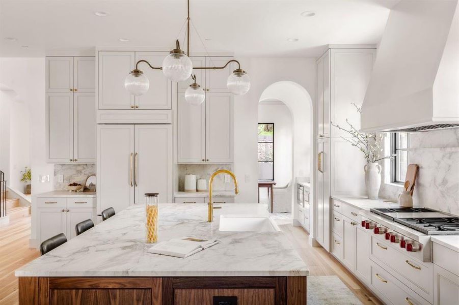 The kitchen is a chef’s dream, boasting Wolf appliances and honed marble countertops that make both daily meals and entertaining feel indulgent