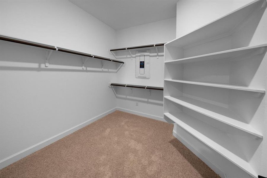 You will love the spacious walk-in closet, easily accessed from the master en suite bathroom. Enjoy the luxury of having additional wooden shelving for storage.