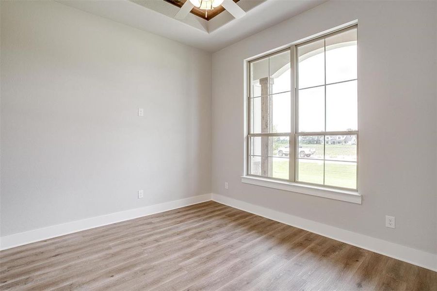 Unfurnished room with light hardwood / wood-style floors and ceiling fan