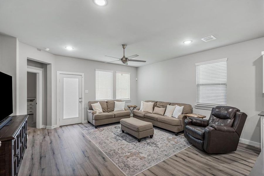 Living room featuring ceiling fan and wood-type flooring