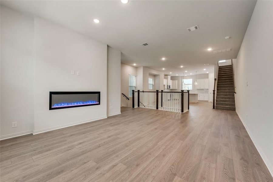 Unfurnished living room featuring light wood-type flooring