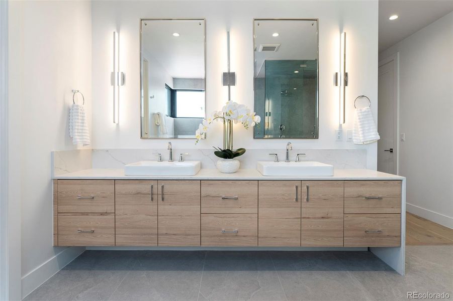luxurious primary bathroom with radiant floors and steam sower