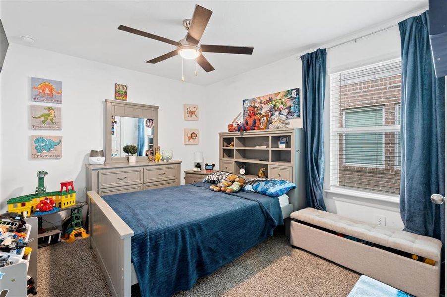 This secondary bedroom features a ceiling fan, with ample natural light. Approximate Measurements: 14x10