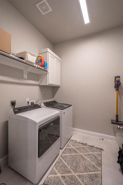 The laundry room measures 8x7 with storage cabinets and plenty of space for all of your laundry needs.