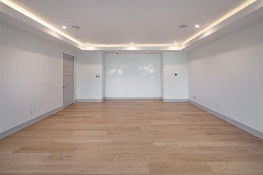 Alternate view of the oversized primary bedroom with trey lit ceiling and hanging reading pendants