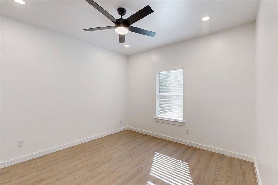 Spare room featuring ceiling fan and light wood-type flooring