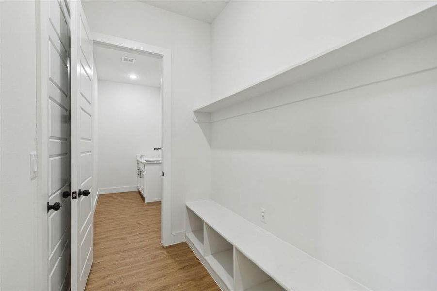 Mudroom with light hardwood / wood-style floors