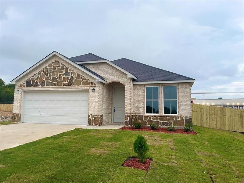 View of front of house with a front yard and a garage