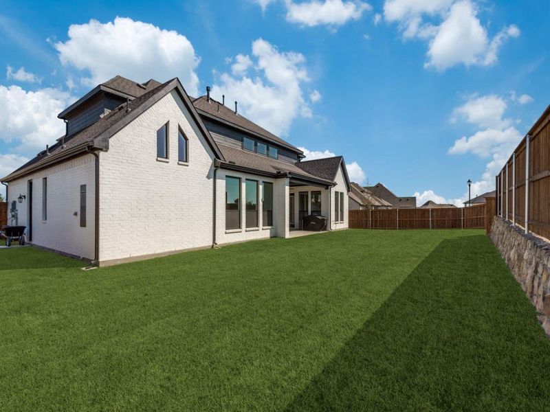 Rear view of house with a lawn