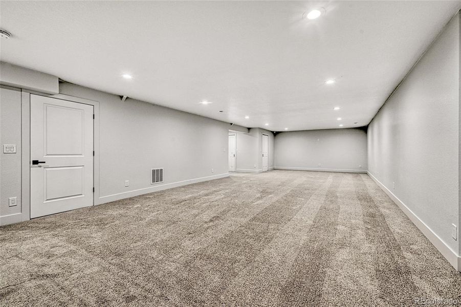 The large great room area is perfect for just about anything including a movie room, teen retreat, craft area, music room, anything! Enjoy the custom lighting and plush carpet flooring.