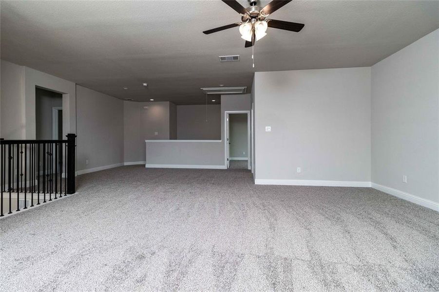 Empty room featuring carpet and ceiling fan