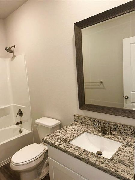 Bath 2 includes granite counters, framed mirror & ceramic tile tub/shower walls