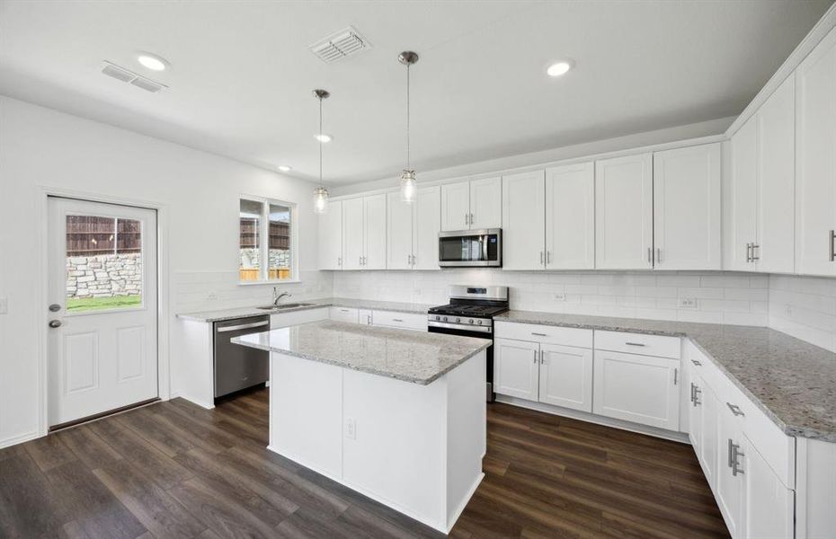 Airy kitchen with oversized island *real home pictured