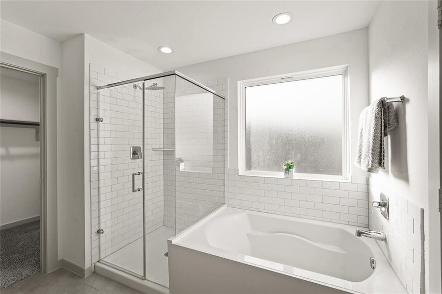 Soothing and gracefully styled bathroom with a deep soaking tub and separate shower with subway tile surround