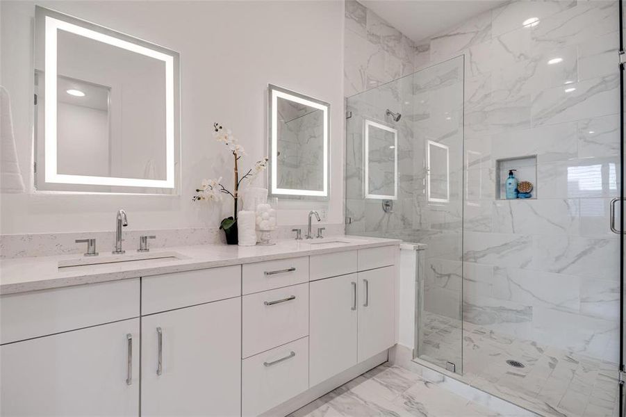 Bathroom featuring vanity and an enclosed shower