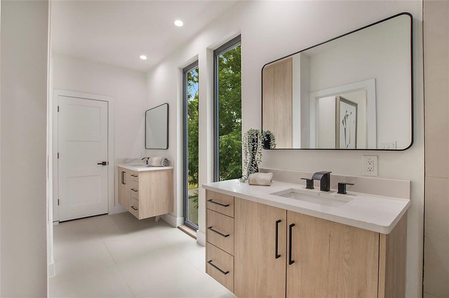 Bathroom featuring a shower with shower door and vanity