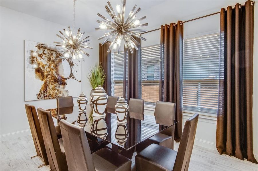 Dining space featuring a notable chandelier and light hardwood / wood-style flooring