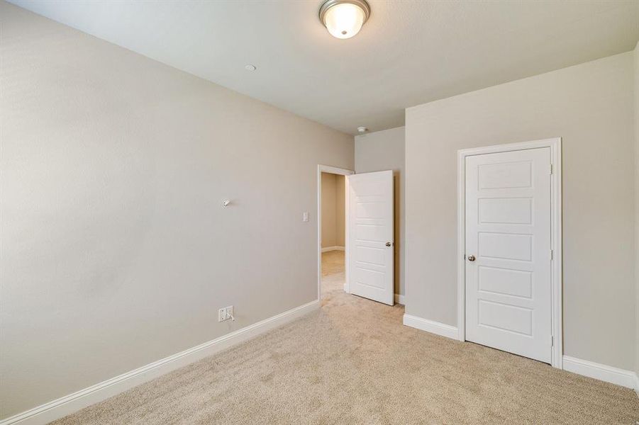 Unfurnished bedroom with a closet and light colored carpet