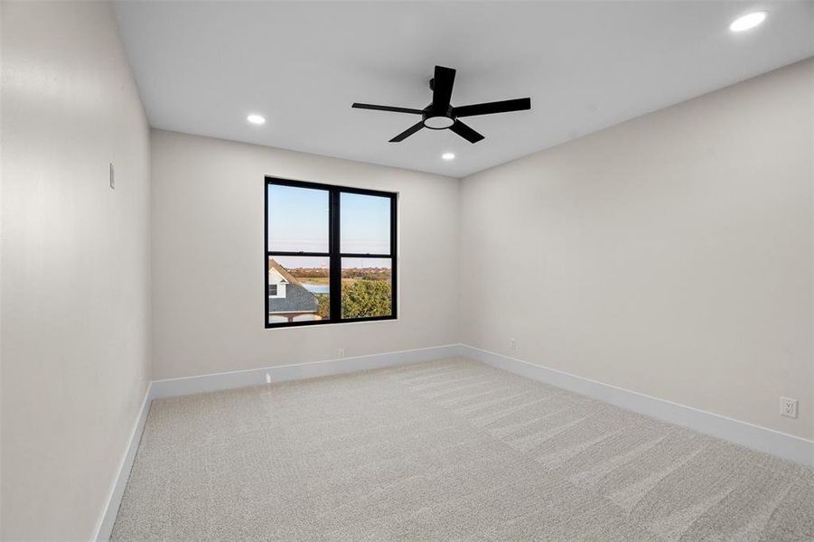 Carpeted spare room with ceiling fan