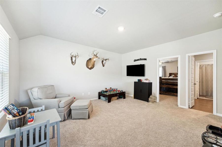 Just up the stairs, is this very large gameroom area! It is made more functional by the high ceilings, large windows and comfy carpet. The mounted tv and mounts will be removed prior to closing.