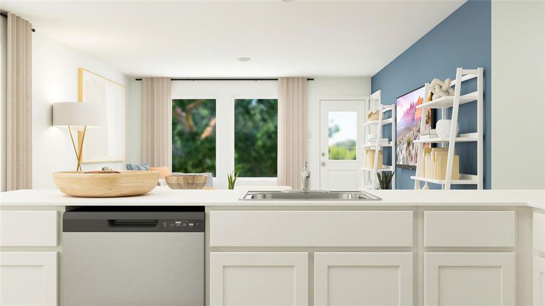 Kitchen with white cabinetry, dishwasher, and sink