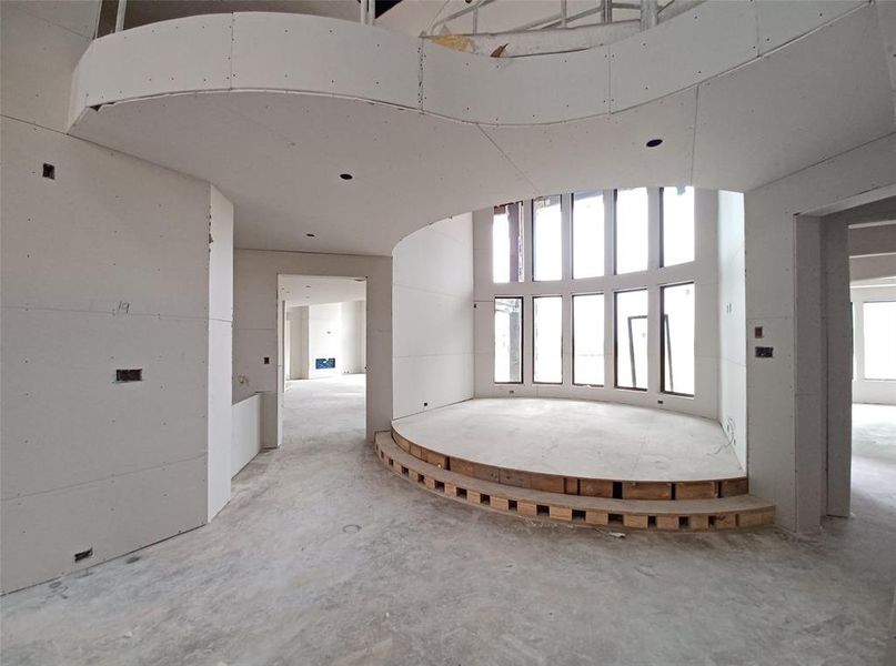 View of the exquisite, elevated living room with stacked windows towards the Kitchen and Family Room