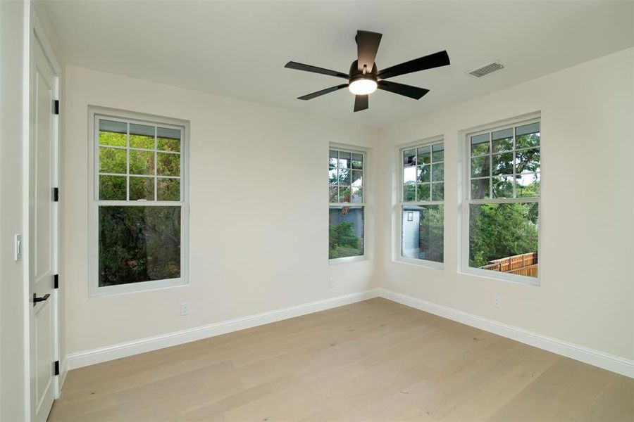 Empty room featuring ceiling fan and light hardwood / wood-style floors