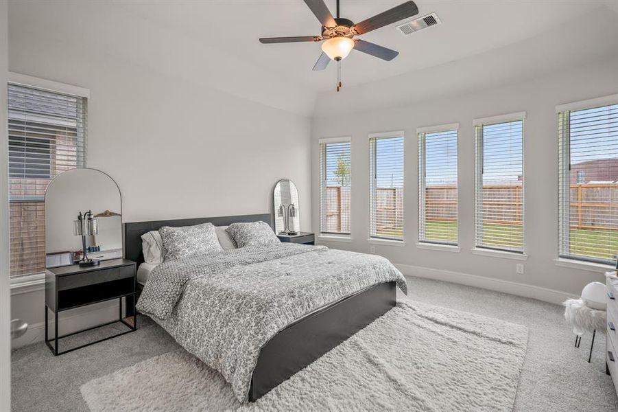 The primary bedroom welcomes you with bright natural light, an upgraded bow window with a relaxing sitting area, and the perfect view of the serene yard. It sits at the back of the home offering additional privacy and easily fits a king size bed plus furniture!