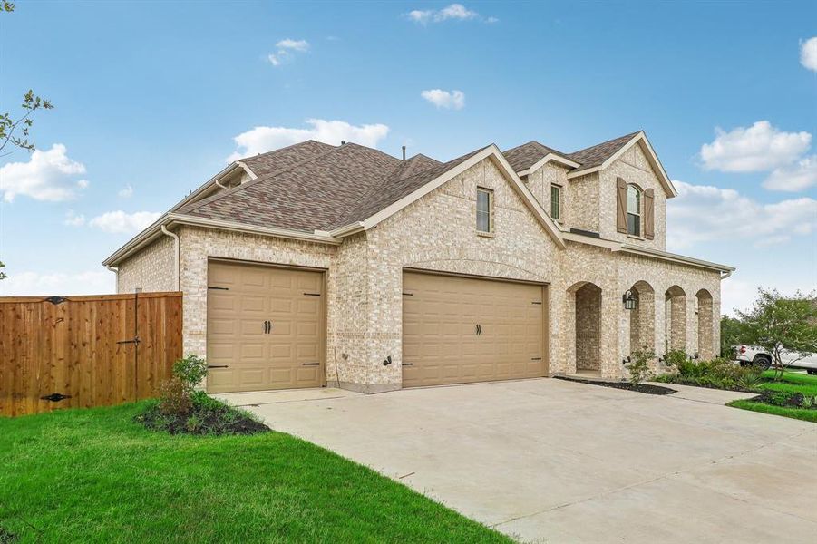 View of front of property with a garage and a front yard