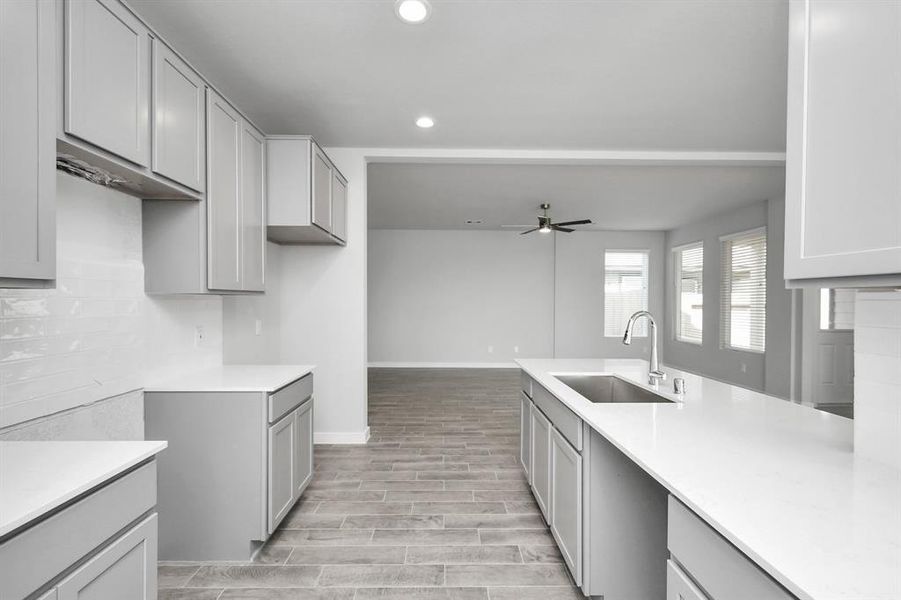 Discover another perspective of this stunning kitchen, generously appointed with an abundance of counter space