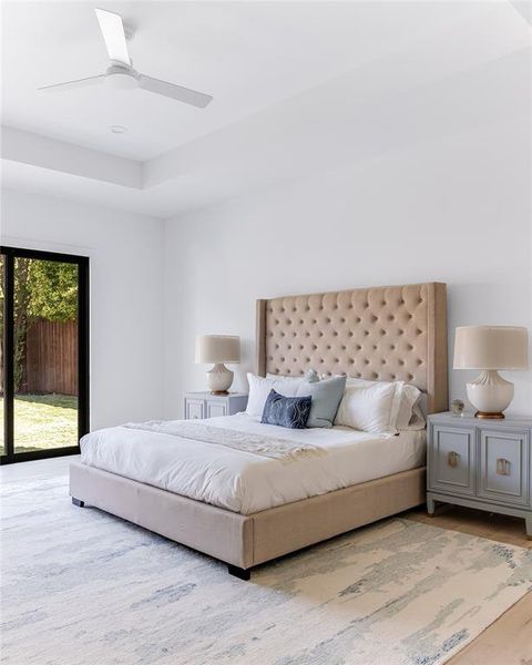 Bedroom with access to exterior, light hardwood / wood-style floors, and ceiling fan