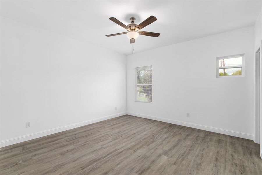 Empty room featuring ceiling fan and wood-type flooring